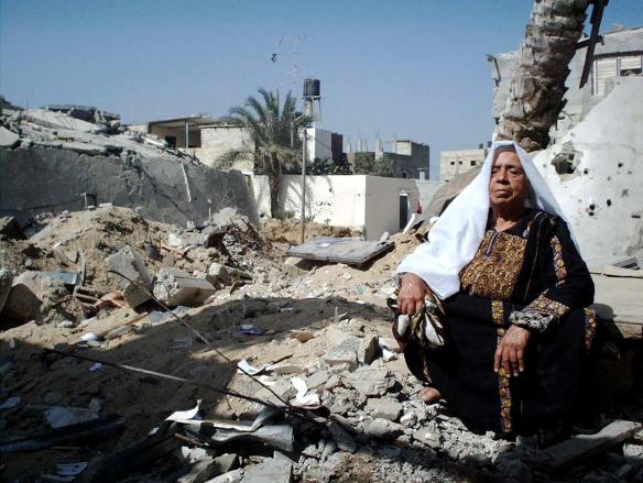 A Palestianian woman in Gaza, next to rubble created by the Israeli military, for her sitting pleasure, I assume.